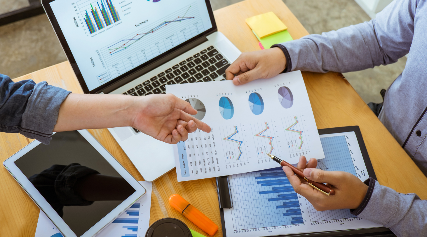 office workflow with focus on documentation with graphs and charts colleagues focused on documentation with graphs and charts